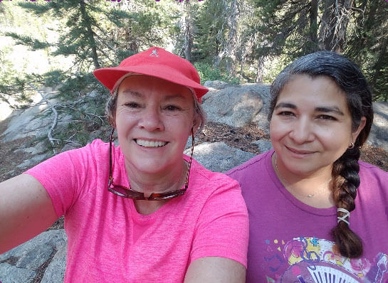 Women taking a selfie while resting on a hike